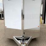 Enclosed aluminum cargo trailer with diamond-plate trim and hitch, branded Enbeck Aluminum Products at the front corner.