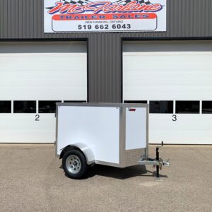 Facade of a gray industrial building with two white roll-up doors; a small silver enclosed trailer parked in front. Above is a sign reading 'McFarlane Trailer Sales, New Hamburg, Ontario, 519-662-6043'.