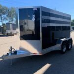 image2 64 - McFarlane Trailer Sales Black enclosed horse trailer with diamond-plate edges and a white horse-head logo on the door, parked in a trailer lot.