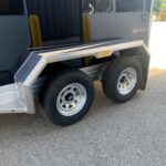 image4 57 - McFarlane Trailer Sales Dual-axle trailer side with diamond-plate fenders, black body, and AgHAUL logo visible.